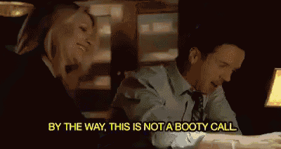 a man and a woman are sitting at a table and the man is saying by the way this is not a booty call