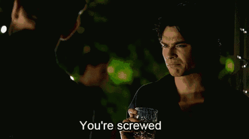 a man is holding a glass of whiskey and saying you 're screwed .
