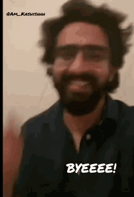 a man with a beard and glasses is smiling and saying byeeee