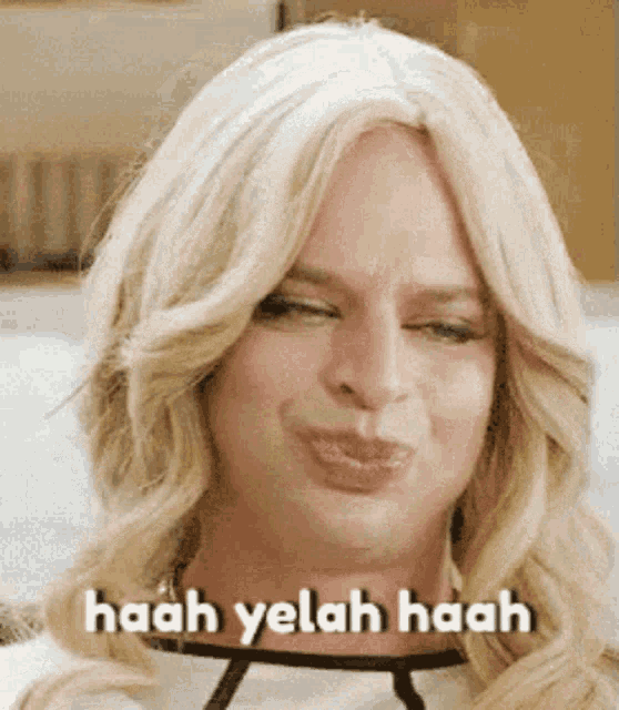 a close up of a woman 's face with the words haah yelah haah