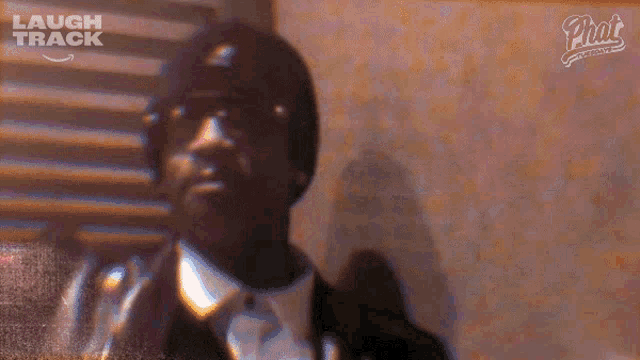 a man in a suit and tie is on a laugh track advertisement