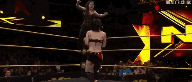 a man is laying on the ground in a wrestling ring .