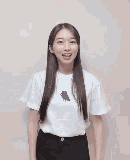 a woman wearing a white shirt and black shorts is dancing