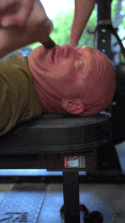 a man is laying on a bench with the word rogue on the side