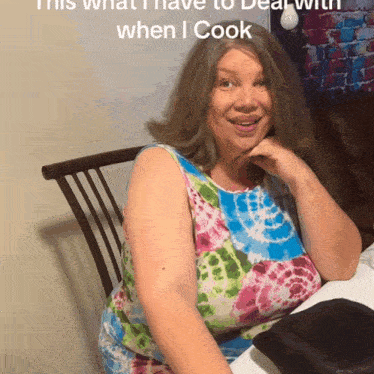 a woman sits at a table with the words " this what i have to deal with when i cook " on the bottom