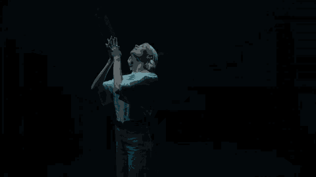 a woman in a white shirt with her arms outstretched