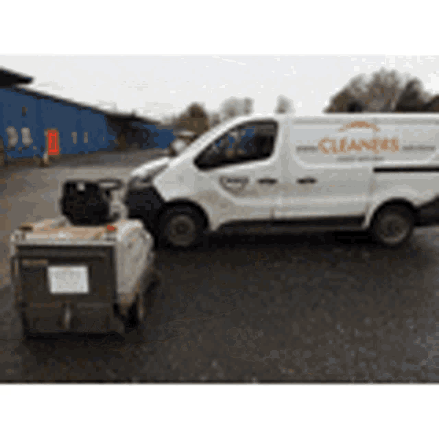 a white van with the word cleaners on the side is parked next to a small machine