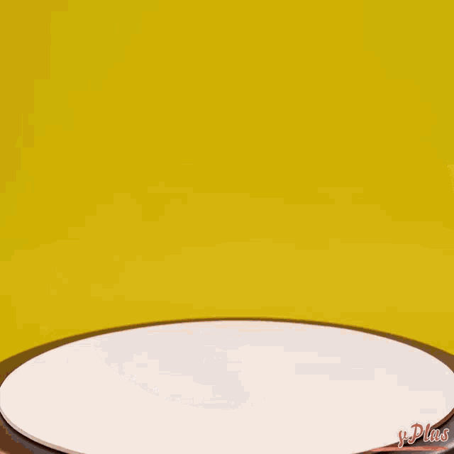 a person is cutting a piece of cake on a white plate with a yellow background behind them