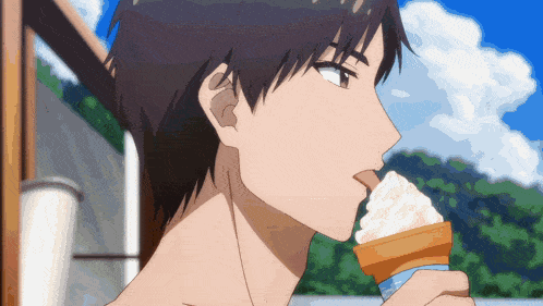 a man is eating an ice cream cone outside