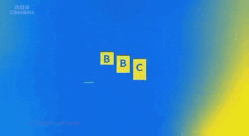 three yellow blocks with faces are sitting next to each other on a blue surface .