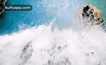 an aerial view of a waterfall with the website kulfyapp.com in the lower right corner