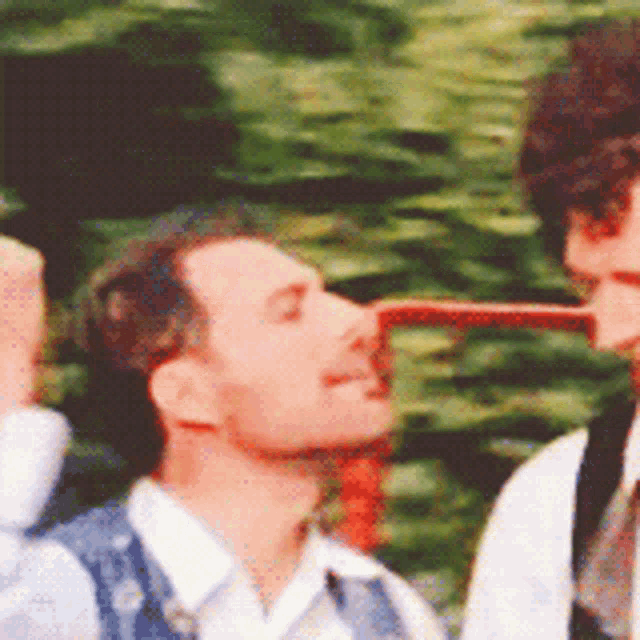 two men are standing next to each other and one of them has a very long nose