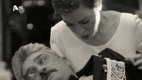 a black and white photo of a woman holding a man with a hd logo on the bottom