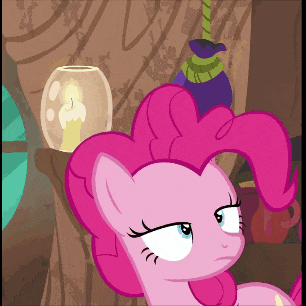 a pink pony with a candle in a glass jar behind it