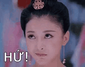 a close up of a woman 's face with a crown on her head and the words hu !