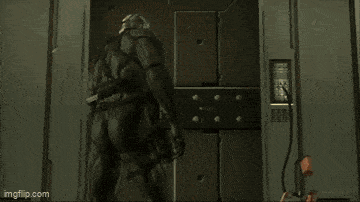 a man in a black suit is standing in a doorway ..