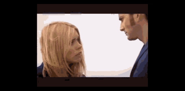 a man and woman are looking at each other .