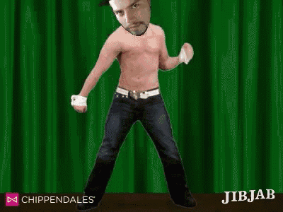 a shirtless man is standing in front of a green curtain .