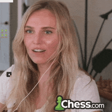 a woman is wearing headphones and a chess.com logo is behind her