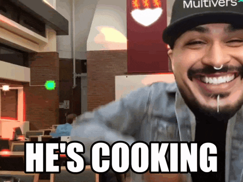 a man wearing a hat that says multivers on it smiles and says he 's cooking