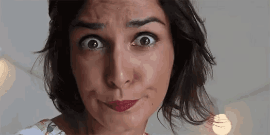 a woman is making a funny face with her mouth open