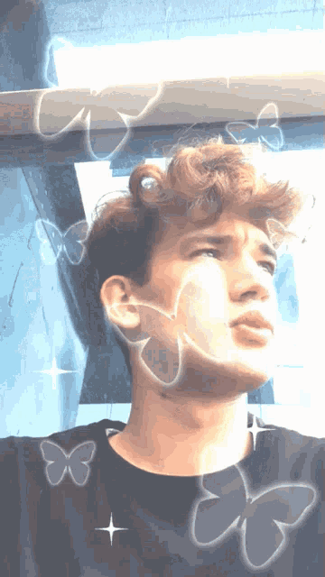 a man with butterflies around his face and a star in the middle