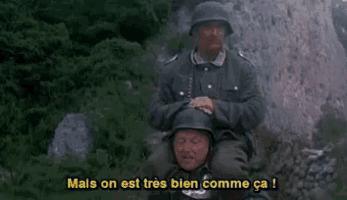 a man in a military uniform is carrying another man on his shoulders and says mais on est tres bien comme ca !