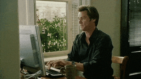a man sits at a desk using a computer