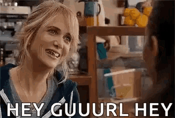 a woman is smiling and talking to another woman in a coffee shop .