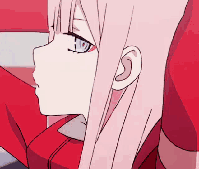 a girl with pink hair and blue eyes is wearing a red shirt and tie .