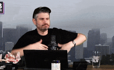 a man sitting at a desk with a dell laptop on it
