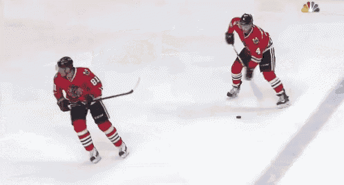 a hockey game is being played in front of a nbc advertisement