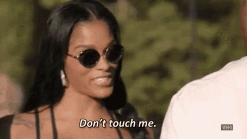 a woman wearing sunglasses is talking to a man and saying `` do n't touch me '' .
