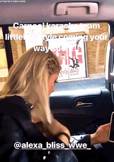 a woman in a car with the words alexa bliss wwe on the bottom right
