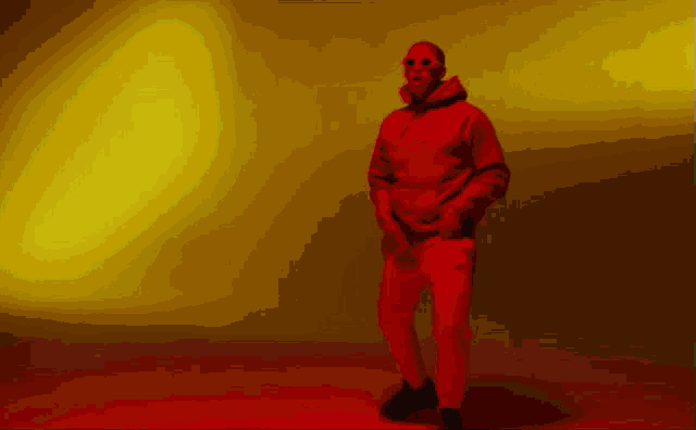 a man in a red hoodie and red pants is dancing