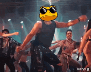 a man wearing sunglasses and a frog face is dancing in a club .