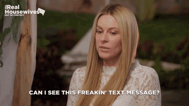 a woman in a white lace top says can i see this freakin text message