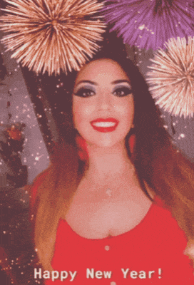 a woman in a red top is surrounded by fireworks and says " happy new year "