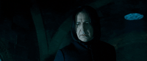 a man in a hooded cloak is pointing at something