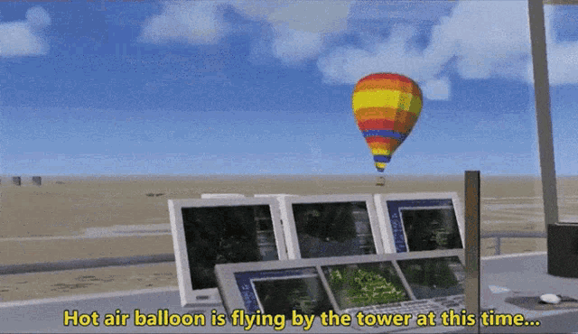 a computer screen shows a hot air balloon flying by the tower