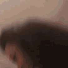 a close up of a person 's face with a blurry background
