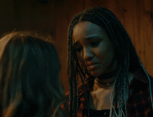 a woman with dreadlocks is kissing another woman