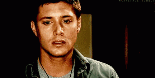 a close up of a man 's face with a tear running down his face .