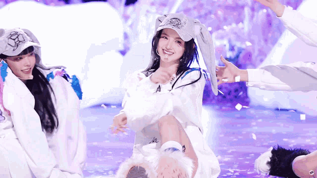 a girl wearing bunny ears and a hat with the letter a on it
