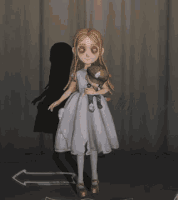 a girl in a white dress holding a stuffed animal