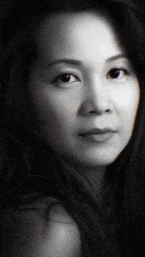 a black and white photo of a woman 's face with long hair
