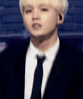 a close up of a man in a suit and tie .