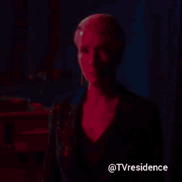 a woman in a blue sequined jacket is standing in front of a blue curtain with the words tvresidence below her