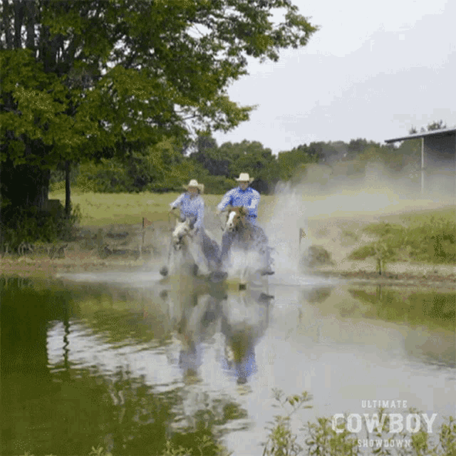 two cowboys are riding horses through a body of water with the ultimate cowboy showdown logo in the background