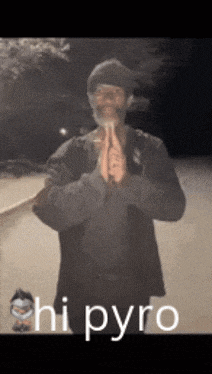 a man with a beard is praying with the words " hi pyro " behind him